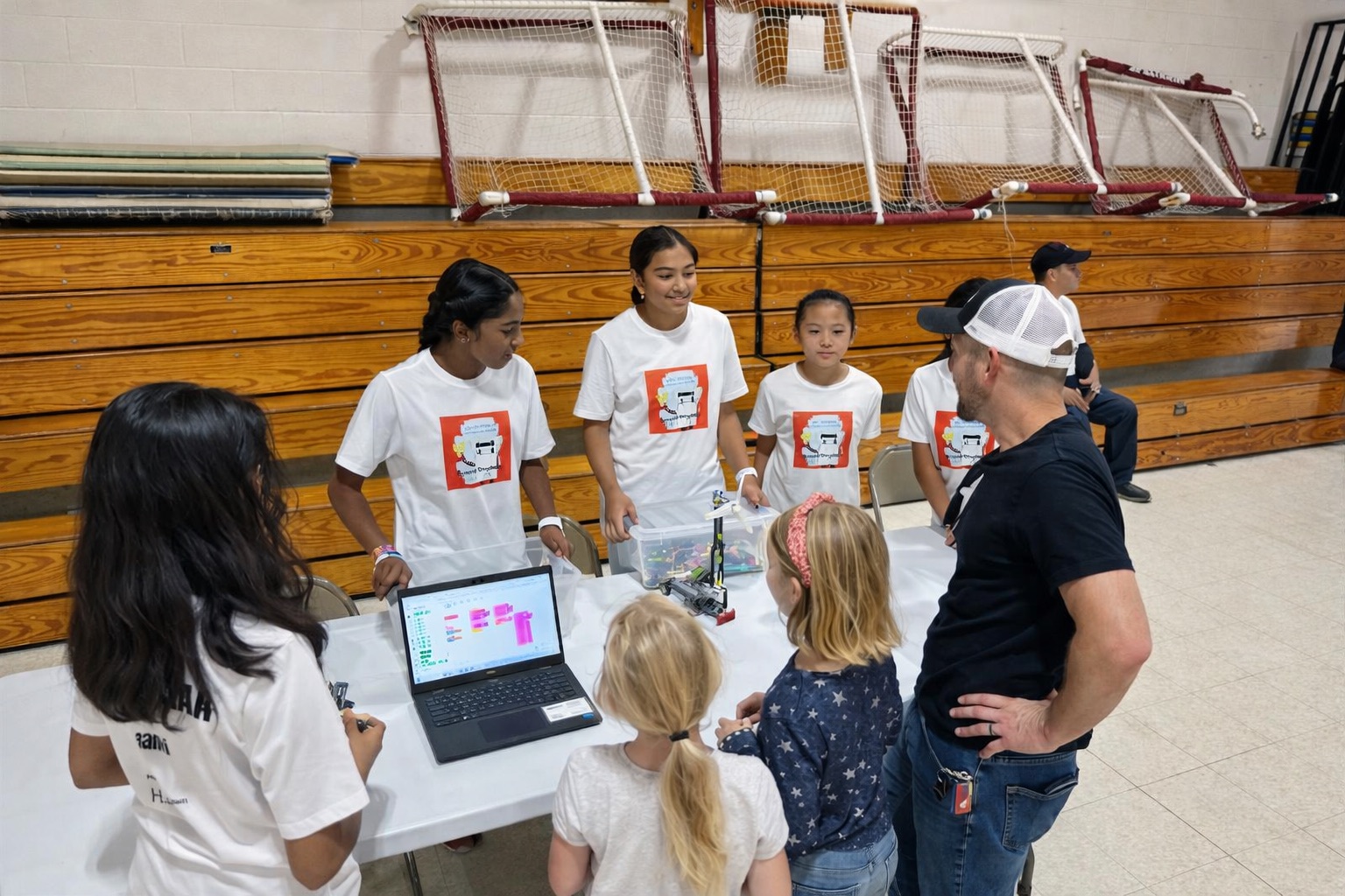 H.E.R.O. mentoring an FLL team through hands-on robotics instruction